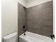 Clean bathroom featuring a white tub and neutral-toned tile surround at 1941 Quarry Park Nw Pl, Atlanta, GA 30318