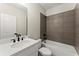 Modern bathroom with stylish vanity and bathtub, adorned with dark grey accent tiling at 1941 Quarry Park Nw Pl, Atlanta, GA 30318