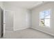 Bedroom with neutral carpet, white walls, and a view of the neighborhood at 1941 Quarry Park Nw Pl, Atlanta, GA 30318