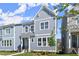 Stylish townhome featuring gray vertical siding, a covered entry, and pristine landscaping at 1941 Quarry Park Nw Pl, Atlanta, GA 30318