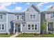 Charming two-story townhome with gray siding, white trim, and a well-manicured front yard at 1941 Quarry Park Nw Pl, Atlanta, GA 30318