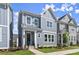 Attractive gray townhome with white accents, a covered entryway, and a lush green lawn at 1941 Quarry Park Nw Pl, Atlanta, GA 30318
