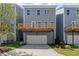 Exterior view of the home, showcasing a one-car garage and a wood deck at 1941 Quarry Park Nw Pl, Atlanta, GA 30318