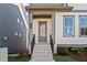 Charming home featuring covered front entry with brick stairs and wrought iron railing at 1941 Quarry Park Nw Pl, Atlanta, GA 30318