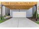 Attached one car garage with a concrete driveway in front of the grey home at 1941 Quarry Park Nw Pl, Atlanta, GA 30318