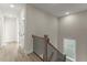 Bright hallway showcasing modern wood floors and a staircase with wooden handrail and black iron spindles at 1941 Quarry Park Nw Pl, Atlanta, GA 30318