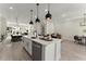 Open concept kitchen with white cabinetry, a large island, and modern pendant lighting at 1941 Quarry Park Nw Pl, Atlanta, GA 30318