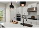Charming kitchen with white cabinets, quartz counters, modern hardware, and stainless appliances at 1941 Quarry Park Nw Pl, Atlanta, GA 30318