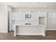 Bright kitchen with white cabinets, stainless steel appliances, and a central island with modern pendant lighting at 1941 Quarry Park Nw Pl, Atlanta, GA 30318
