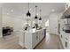Modern kitchen with white cabinets, stainless steel appliances, and an island with pendant lighting at 1941 Quarry Park Nw Pl, Atlanta, GA 30318