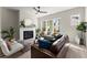 Cozy living room with a fireplace, large windows, and contemporary furnishings at 1941 Quarry Park Nw Pl, Atlanta, GA 30318