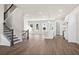 Spacious open-concept living area featuring hardwood floors, modern finishes, and staircase at 1941 Quarry Park Nw Pl, Atlanta, GA 30318