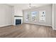 Cozy living room featuring a modern fireplace with white brick and dark wood mantle, plus lots of light at 1941 Quarry Park Nw Pl, Atlanta, GA 30318