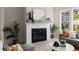 Bright living room featuring a modern fireplace with white brick surround and stylish decor at 1941 Quarry Park Nw Pl, Atlanta, GA 30318