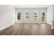 Bright living room with hardwood floors, white trim, and large windows offering plenty of natural light at 1941 Quarry Park Nw Pl, Atlanta, GA 30318