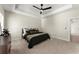 Inviting main bedroom with a tray ceiling, fan, neutral carpet, and ample space at 1941 Quarry Park Nw Pl, Atlanta, GA 30318