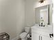 Modern powder room with white vanity, matte black fixtures, and neutral wall color at 1941 Quarry Park Nw Pl, Atlanta, GA 30318