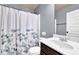 Tidy bathroom featuring a vanity with white sink and dark wood cabinet, shower, and floral curtain at 2040 Browning Bend Ct, Dacula, GA 30019