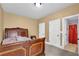 Cozy bedroom featuring neutral carpet, a ceiling light, and a doorway to an attached bathroom at 2040 Browning Bend Ct, Dacula, GA 30019