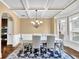 Elegant dining room featuring coffered ceilings, wainscoting, and a bay window for ample natural light at 2040 Browning Bend Ct, Dacula, GA 30019