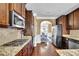 Well-equipped kitchen with stainless steel appliances, granite countertops, and dark wood cabinetry at 2040 Browning Bend Ct, Dacula, GA 30019