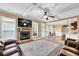 Inviting living room with a stone fireplace, coffered ceiling, and an open layout to the kitchen at 2040 Browning Bend Ct, Dacula, GA 30019