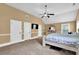 Spacious main bedroom with vaulted ceilings, neutral carpet, a ceiling fan, and ample closet space at 2040 Browning Bend Ct, Dacula, GA 30019