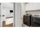 Modern laundry room features new black stainless steel appliances, white cabinets, and views to bedroom at 205 Wilbur Se Ave # A, Atlanta, GA 30316