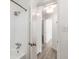 Modern bathroom featuring a shower and hardwood flooring; hallway beyond at 4820 Roswell Mill Dr, Alpharetta, GA 30022