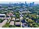 Aerial view showcases a neighborhood surrounded by lush greenery and the Atlanta skyline at 8 Honour Nw Ave # 6, Atlanta, GA 30305