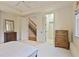 This bedroom features a neutral color palette, hardwood floors in the hallway and stairs and a double door entry at 8 Honour Nw Ave # 6, Atlanta, GA 30305