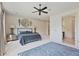 Spacious bedroom featuring a ceiling fan, decorative wall art, and an ensuite bathroom entrance at 8 Honour Nw Ave # 6, Atlanta, GA 30305