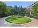 Beautifully landscaped courtyard with a fountain, manicured hedges, and brick pathways at 8 Honour Nw Ave # 6, Atlanta, GA 30305