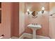 Stylish powder room featuring patterned wallpaper, pedestal sink, and decorative sconces at 8 Honour Nw Ave # 6, Atlanta, GA 30305