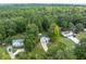 Aerial view of the home and neighborhood with mature trees at 152 Country Cottage Cir, Carrollton, GA 30116