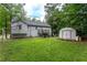 This large backyard features a shed, soccer net and back deck at 152 Country Cottage Cir, Carrollton, GA 30116