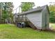 A fenced backyard with a deck, shed and soccer net has plenty of room to play at 152 Country Cottage Cir, Carrollton, GA 30116