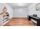 An empty finished basement with wood flooring is ready for you to make it your own at 152 Country Cottage Cir, Carrollton, GA 30116