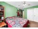 Inviting bedroom featuring green walls, neutral carpet and a cozy quilt at 152 Country Cottage Cir, Carrollton, GA 30116