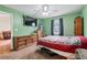 Bright bedroom with green walls, carpet flooring, and comfortable furnishings at 152 Country Cottage Cir, Carrollton, GA 30116