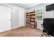 Sunlit bedroom offering neutral walls, neutral carpet, and a well-organized workspace at 152 Country Cottage Cir, Carrollton, GA 30116