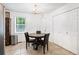 Dining room with tile floor, black dining set, and lots of natural light at 152 Country Cottage Cir, Carrollton, GA 30116