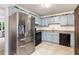 Kitchen with stainless steel refrigerator and light blue cabinets at 152 Country Cottage Cir, Carrollton, GA 30116
