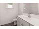 Bathroom featuring a white vanity, tiled floors and a window providing natural light at 1858 Lacebark Elm Way, Lawrenceville, GA 30045
