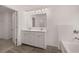 Bathroom featuring double sinks, white cabinets and tile floors at 1858 Lacebark Elm Way, Lawrenceville, GA 30045