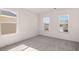 Bright bedroom featuring plush carpeting, white walls, and two windows providing natural light at 1858 Lacebark Elm Way, Lawrenceville, GA 30045