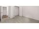 Bright bedroom with carpeted floors, open closet space, and neutral walls at 1858 Lacebark Elm Way, Lawrenceville, GA 30045