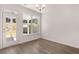 Bright dining room features hardwood floors, white trim, modern lighting and views of the back yard at 1858 Lacebark Elm Way, Lawrenceville, GA 30045