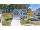 Charming two-story home with a two car garage, neutral paint and manicured landscaping at 1858 Lacebark Elm Way, Lawrenceville, GA 30045