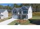 Charming two-story home with a two car garage, neutral paint and manicured landscaping at 1858 Lacebark Elm Way, Lawrenceville, GA 30045